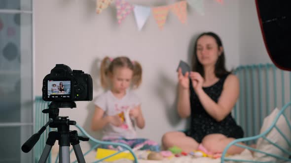 Little Girl with Mother Recording Video Tutorial