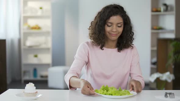 Young Beautiful Woman Choosing Salad Over Cake and Eating, Healthy Food