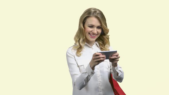 Cheerful Woman Playing Mobile Game