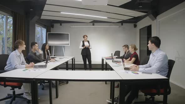 Wide Shot of Office Meeting Room with Confident Concentrated CEO Discussing Strategy with Coworkers