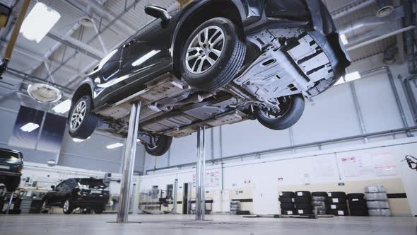 The Work of an Automatic Lift in a Car Workshop