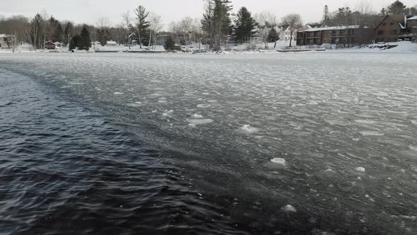 Freezing lake waves ripple aerial 4K