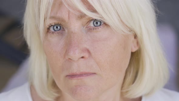 Close-up Face of a Scared Frustrated Mature Woman Looking at Camera