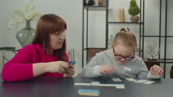 Down Syndrome Girl with Mom Playing Educational Game