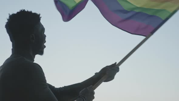 Black Man Waving Rainbow Flag. Sexual Identity Concept