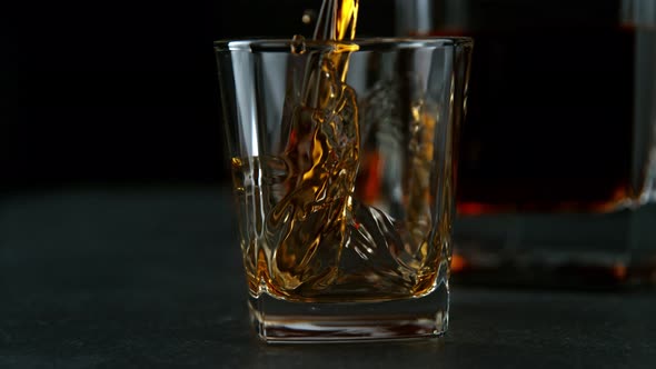 Super Slow Motion Shot of Pouring Whiskey Into Glass at 1000Fps with Camera Movement alt