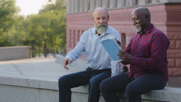 Two Elderly People Mature Adult African American Male Counselor and Old Bearded Colleague Sitting