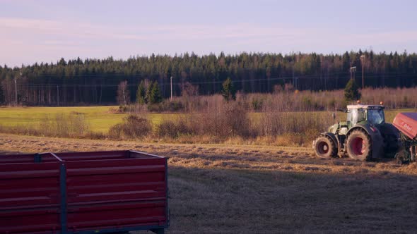 Tractor, harvesting on a wheat field, on the countryside, on a sunny, autumn evening, in Soderhamn,