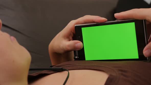 Listening music and looking at  green screen on smart phone 4K 2160p UHD footage - Chroma greenscree