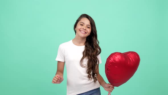 Happy Child Portrait Showing Red Heart Party Balloon with Peace Gesture Sweetheart