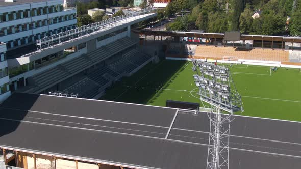 Football players training at Studenternas IP Uppsala stadium in Sweden. Aerial drone tilt down view