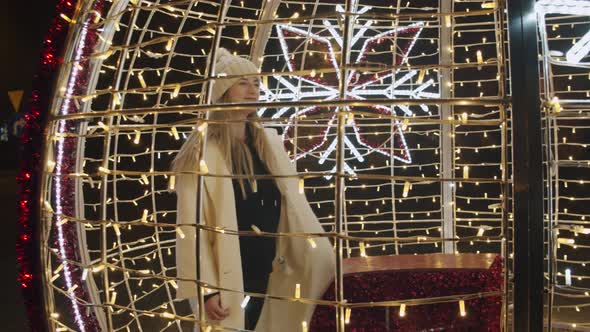 Woman Spins Around in a Christmas Decoration