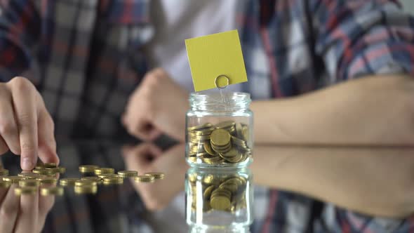 Empty Paper Above Glass Jar With Money, Savings Concept, Investment in Future