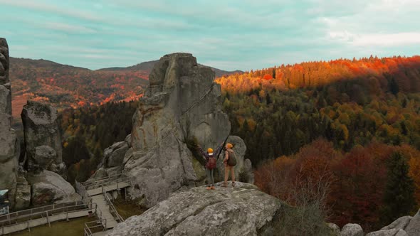 Aerial Happy Smiling Couple Hiker Walks Together in National Park Tustan in Ukraine