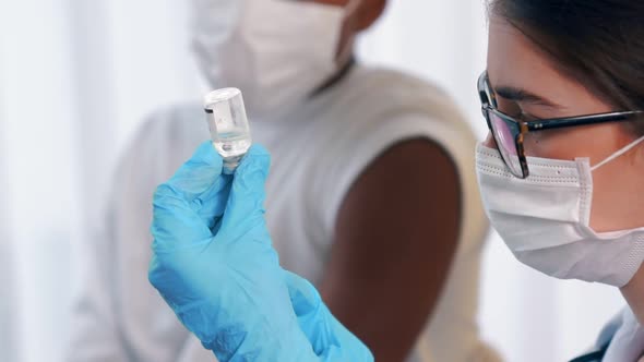 Young Man Visits Skillful Doctor at Hospital for Vaccination