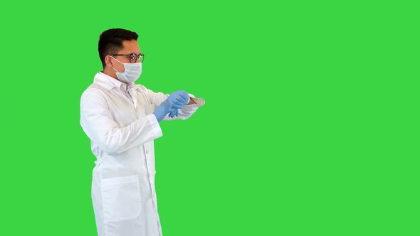 Male Hispanic Doctor Looking at His Watch and Runs Being Late on a Green Screen Chroma Key
