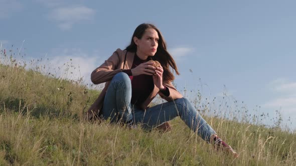 Brunette Female Eat Burger Rest on Nature