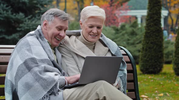 Older Happy Caucasian Husband Wife Mature Elderly Couple Grandparents Family Look at Screen Laptop