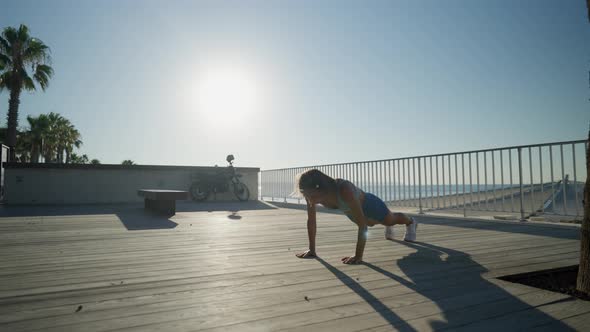 Sportswoman Workout Outdoor on Seaside  She Make Burpee Exercise