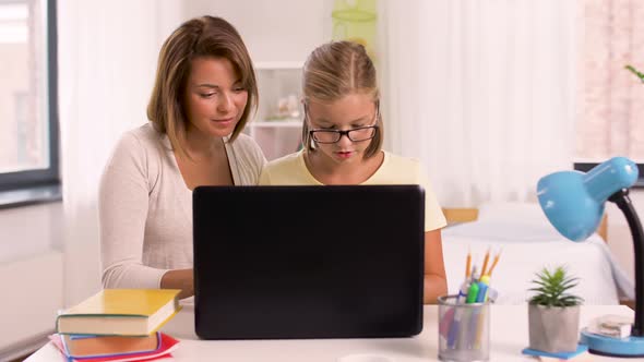 Mother and Daughter with Laptop Doing Homework