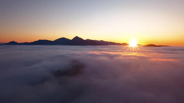 Aerial View of Golden Sunset Above Clouds in Evening Mountains Nature Landscape