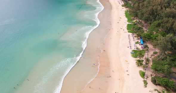 Top view blue sea water waves texture seamless parasols people relax in holiday