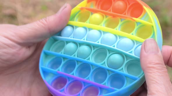 Closeup Shot of Someone Playing with a Pop It Toy