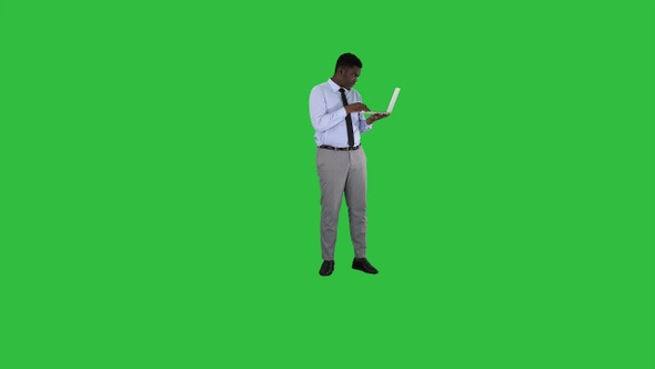 Afro American business man working with laptop on a Green