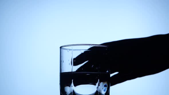 Anonymous Person Taking Glass of Water