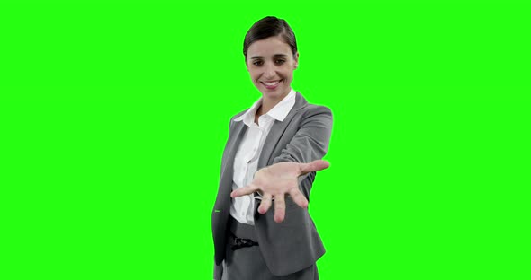 Businesswoman gesturing against green screen