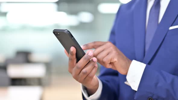 African Businessman Using Smartphone Text Messaging