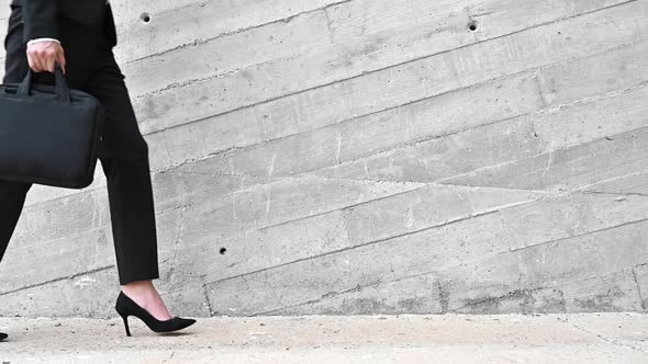 Unrecognizable Business Woman with Briefcase Is Walking in City. Close Up, Slow Motion.