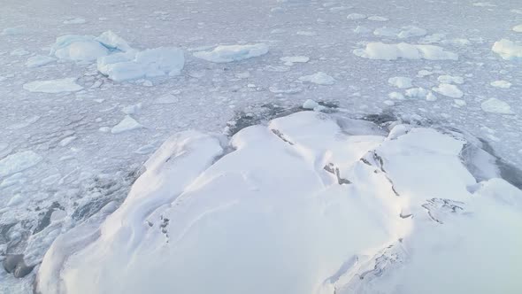 Snow Covered Land, Ice Ocean. Antarctica Shot.