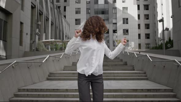 Young Girl In Strict Business Clothes Dancing Near The Office Building