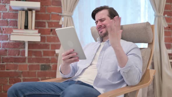 Casual Young Man Having Loss on Tablet on Sofa