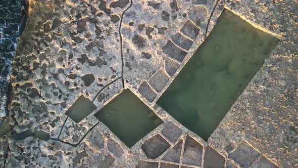 Aerial shot of of salt pans near the  sea in the Malta. Salt pans near Zebbug, Gozo island, Malta