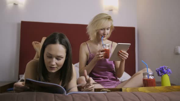 Cheerful Female Friends Having Fun in Bed at Home