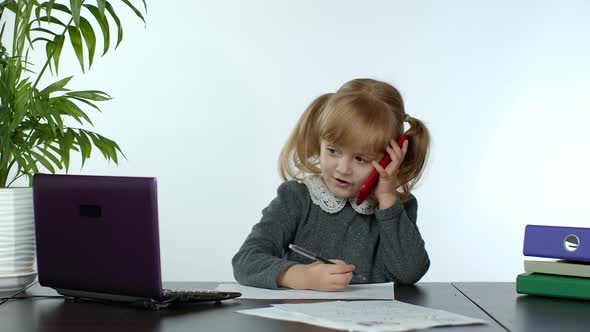 Funny Little Child Girl Boss Manager Emotionally Talking on Mobile Phone, Sitting at Computer Table