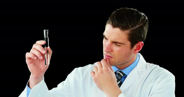 Doctor using digital screen while examining chemical in test tube