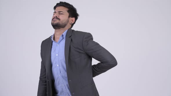 Young Stressed Bearded Indian Businessman Having Back Pain