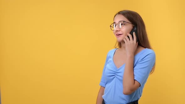 Pleasant Young Female in Eyeglasses Laughing Enjoying Friendly Discussion with Relatives Smartphone