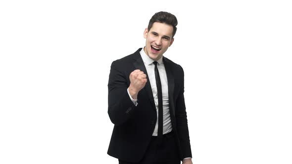 Slow Motion Handsome Young Businessman Doing Victory Gesture About Successful Achievement. Isolated