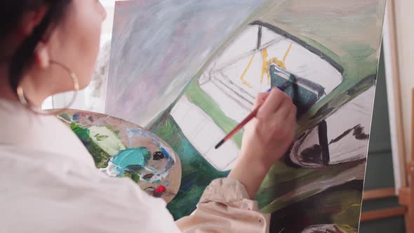 A Woman Artist Drawing on Canvas