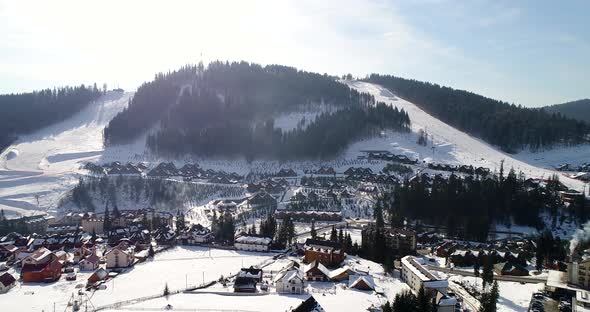 Aerial View Of Village In Valley Between Mountains