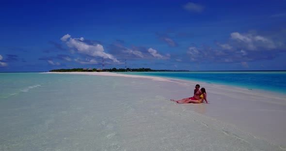 Romantic lady and man on honeymoon vacation have fun on beach on summer white sandy background