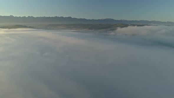 Heavenly scenery with sea of clouds during magical sunrise, aerial