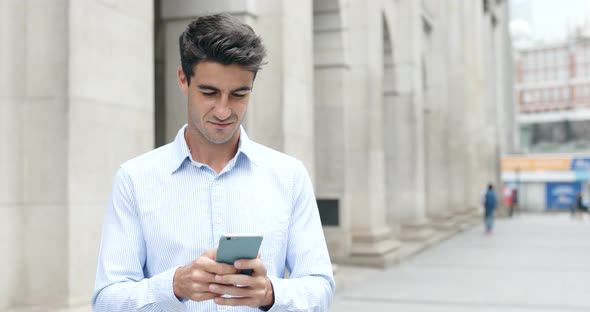 Businessman use of cellphone in Hong Kong city