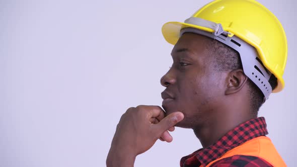 Closeup Profile View of Happy Young African Man Construction Worker Thinking