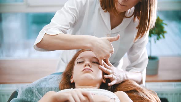 Massage - Massage Therapist Is Pinching the Face of a Woman