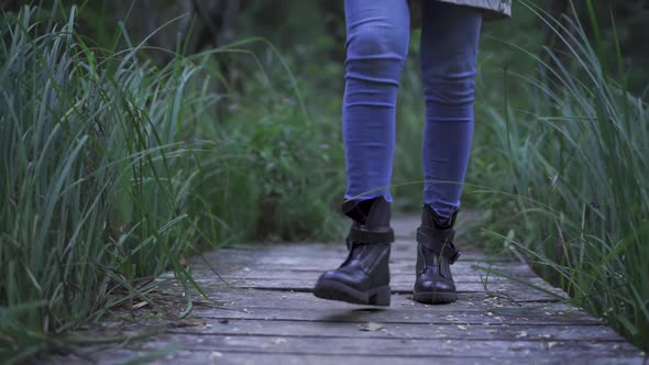 Person In Blue Jeans Walking Towards The Camera alt